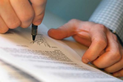 Man's Hands Signing Document